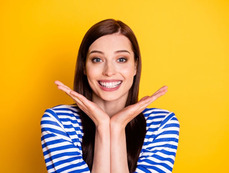 Cheerful young woman showing her beautiful teeth in a smile